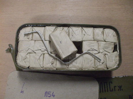 Freshly opened 'Spam Can' of Russian military surplus 7.62x54mmR ammunition. 22 paper packets of 20 rounds each. One central packet lifted out with the cloth ribbon.