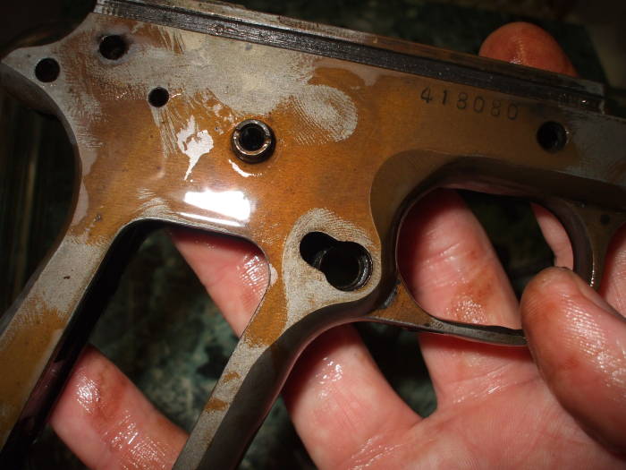 Bluing removal, removing bluing from gun parts with a vinegar bath. Wiping the parts with a paper towel to remove oxidation.