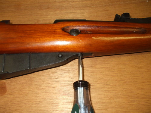 Remove the lower screw holding the magazine to the receiver.