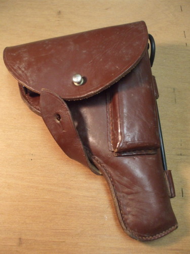 Open the holster and remove the pistol.