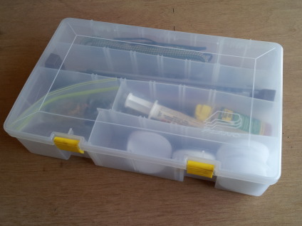 Plastic case filled with gun cleaning tools and supplies.