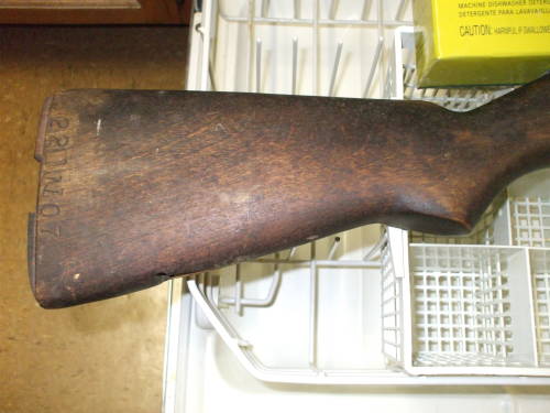 Dishwasher cleaning of an M1 Garand rifle stock. Dark and dirty wood before cleaning.