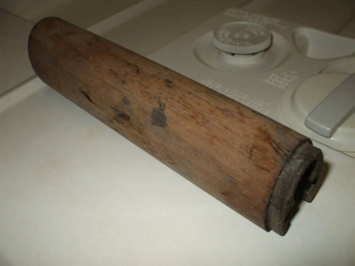 Dishwasher cleaning of an M1 Garand rifle stock.  Dark and dirty wood before cleaning.