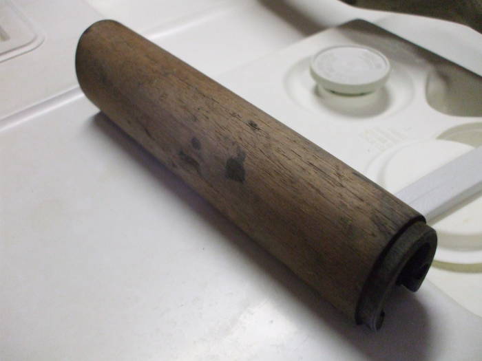 Dishwasher cleaning of an M1 Garand rifle stock. Light wood after cleaning, although some dark oil stains remain.