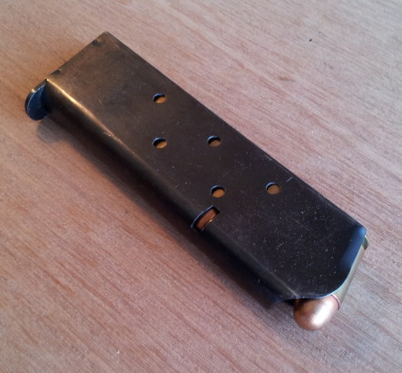 M1911 pistol magazine loaded with .45 ACP cartridges.