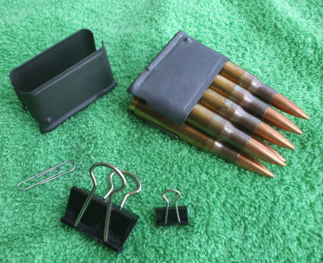 En-bloc clips for the M1 Garand rifle, a paper clip, and two binder clips.