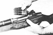 Inserting an 8-round en-bloc clip to load an M1 Garand rifle.